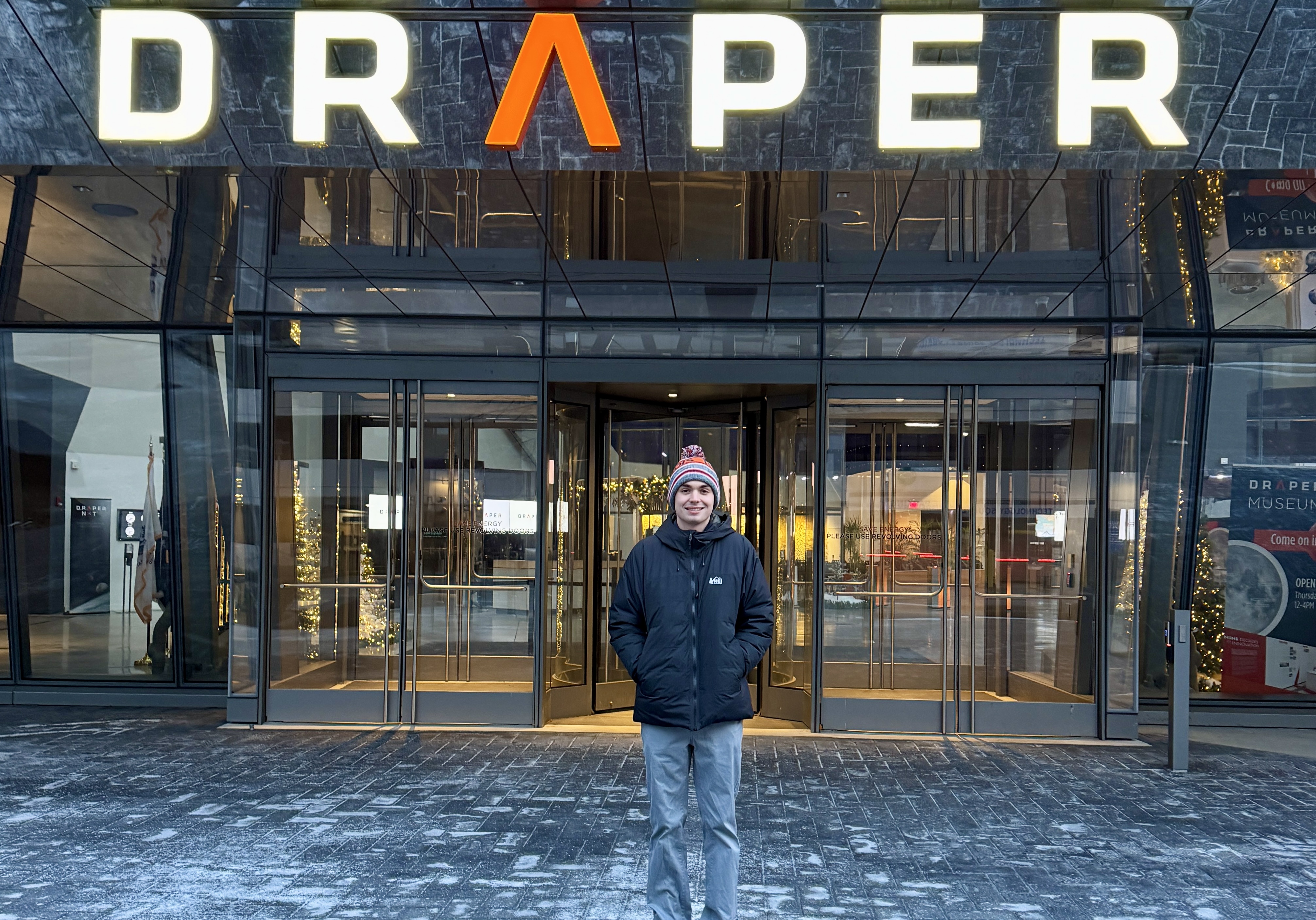 Standing outside the entrance of Draper's Cambridge headquarters.